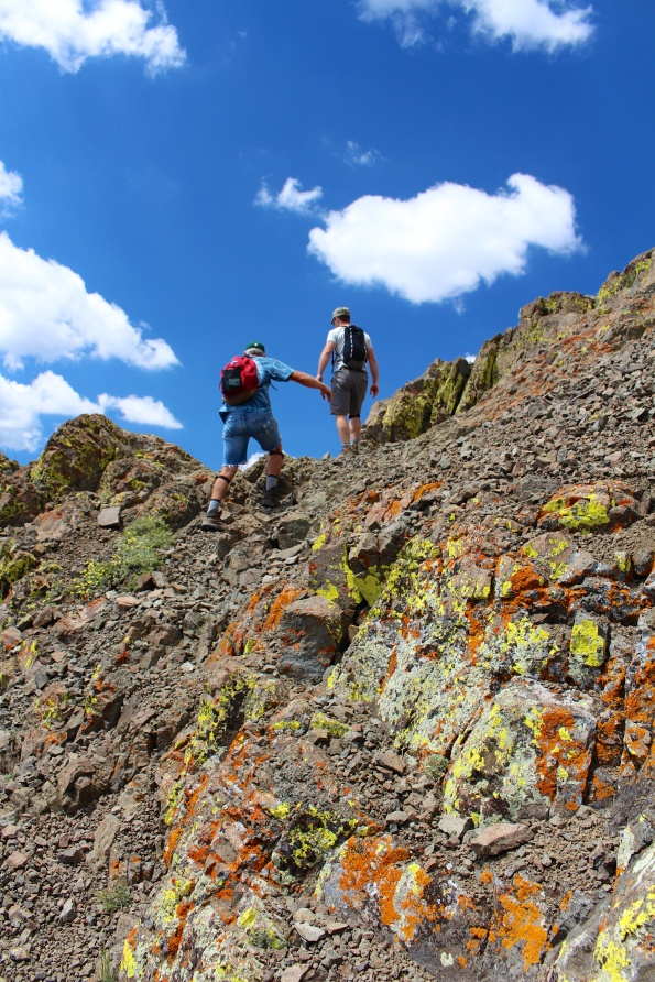 Scrambling up the lichen-crusted rocks
